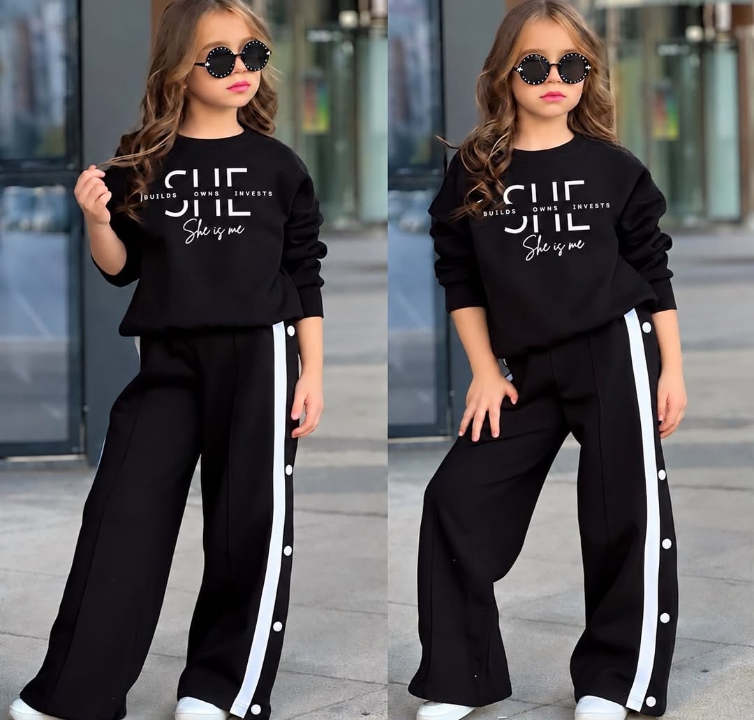 A child models a pink sweatshirt and matching wide-leg track pants with white side stripes, shown in close and full-length views under daylight.
